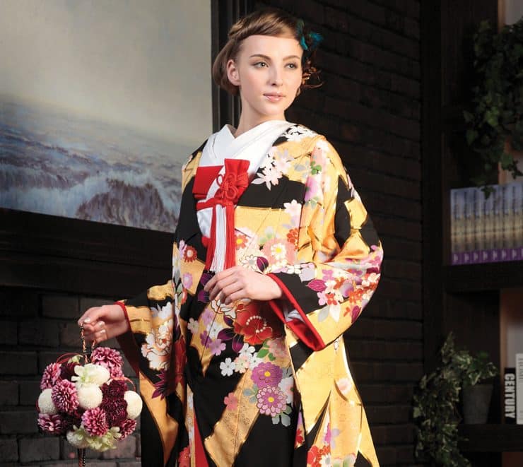 Uchikake. The bride typically wears a white kimono for the ceremony. For the reception, she often wears the uchikake, an elaborate silk robe covered with embroidered flowers and cranes, worn over a kimono.