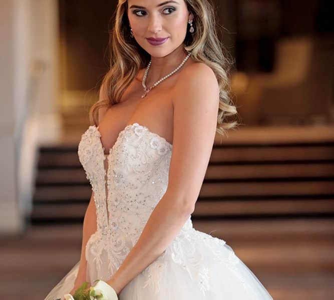 Gown: Eve of Milady (4381). Bouquet: Ariston Flowers.