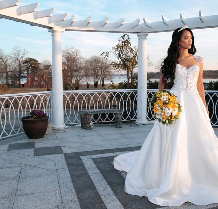 Gown: Eve of Milady (1639). Bouquet: Henry's Florist Floral Decorators.